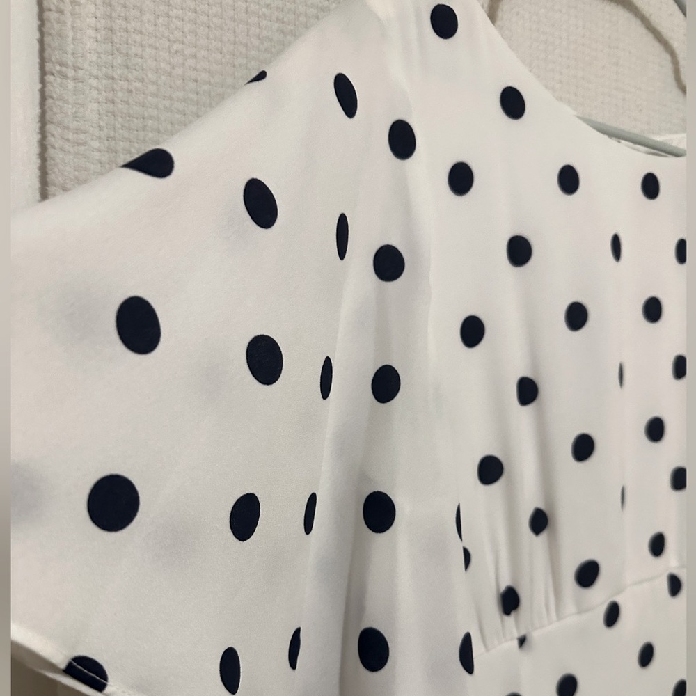 Gabby Skye, 16, white dress with navy blue polka dots. Shear sleeves.